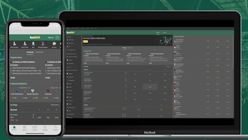 Bet365 website open and visible on an iphone xr and macbook air