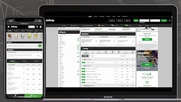 Betway website visible on an iphone xr and a macbook air