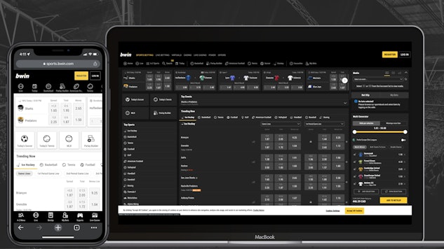 Bwin website open and visible on an iphone xr and a macbook air