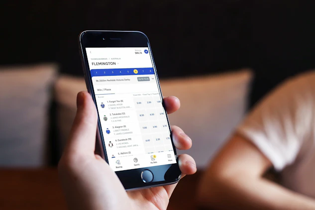 A man betting on horse racing using the moneyball betting app