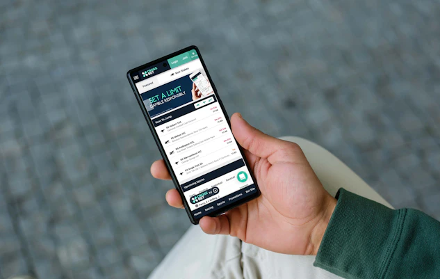 Man using crossbet betting website on android phone
